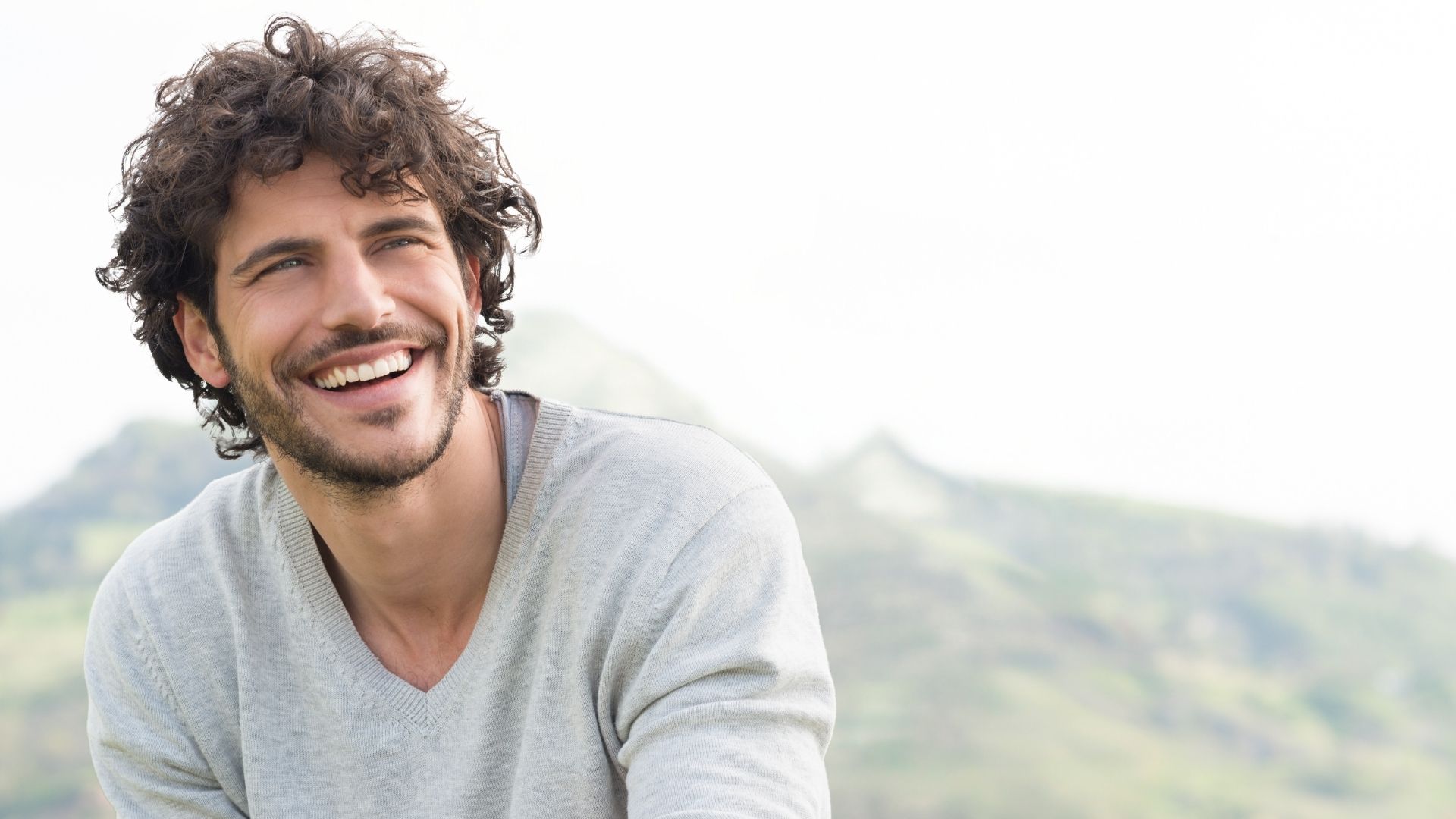 Smiling man enjoying a sense of well-being outdoors