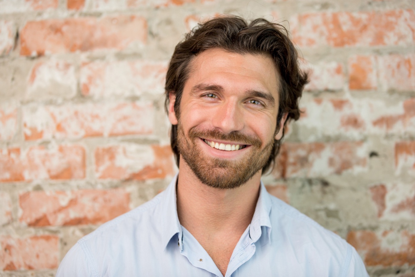 Smiling man feeling energized after IV therapy and NAD+ injections at Optimal Health